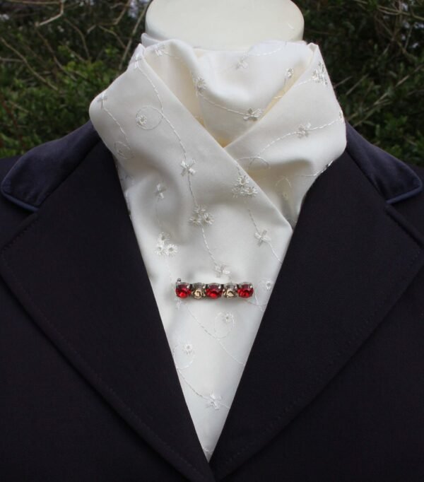 cream embroidery anglaise cotton pre tied stock tie, with an embroidered floral pattern. Shown tied on a mannequin.
